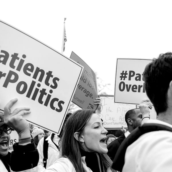 People holding signs in front of the U.S. Supreme Court that read "Patients Over Politics"